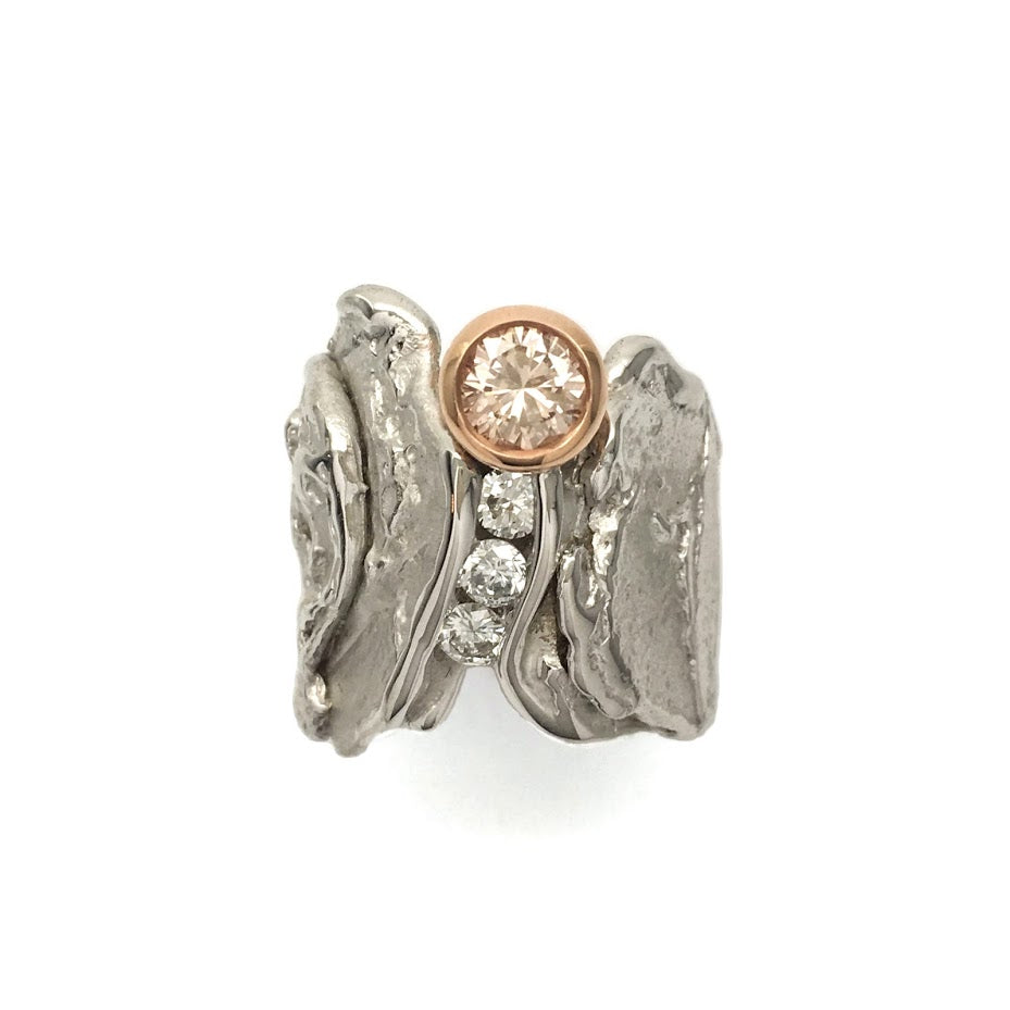 White and rose gold slab ring set with a Fancy Pink-Brown diamond and three colorless diamonds