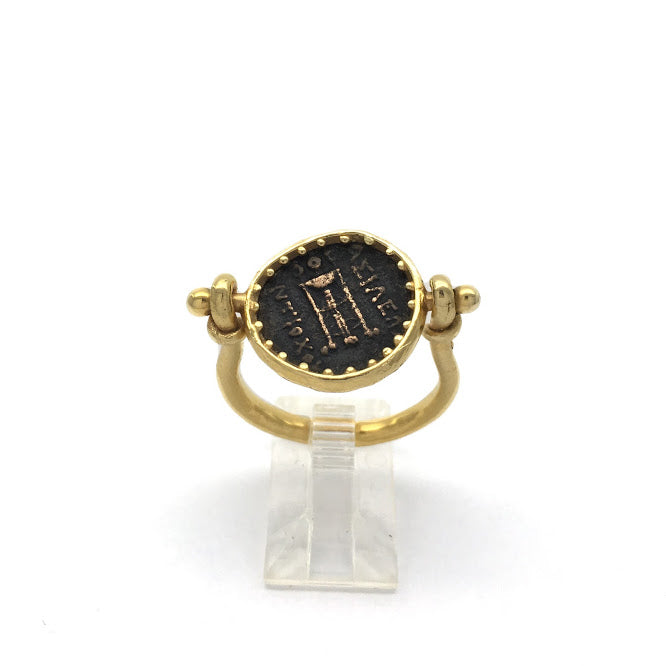Sturup ring featuring an ancient bronze Greek coin with the head of Apollo, set in a way that allows the coin to rotate so that coin can be worn with either side showing