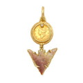 An African arrow head hung from an 1853 U.S. one dollar gold coin accented with a single cognac colored diamond