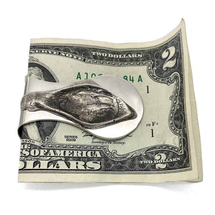 An image taken from a buffalo nickel and then stretched, symbolizing pinching your pennies or stretching your money out as far as it will go