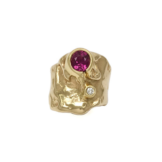 The Caldera ring set with a red pink sapphire
