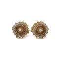 Cross section slice of an citrine crystalized stiglatite with faceted bezel set white sapphire at the center