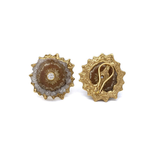 Cross section slice of an citrine crystalized stiglatite with faceted bezel set white sapphire at the center