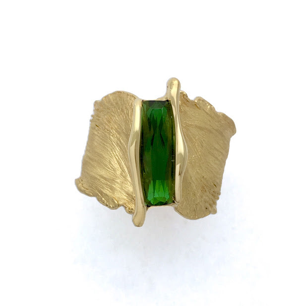 Bright green scissor cut tourmaline set into a feather texture ring