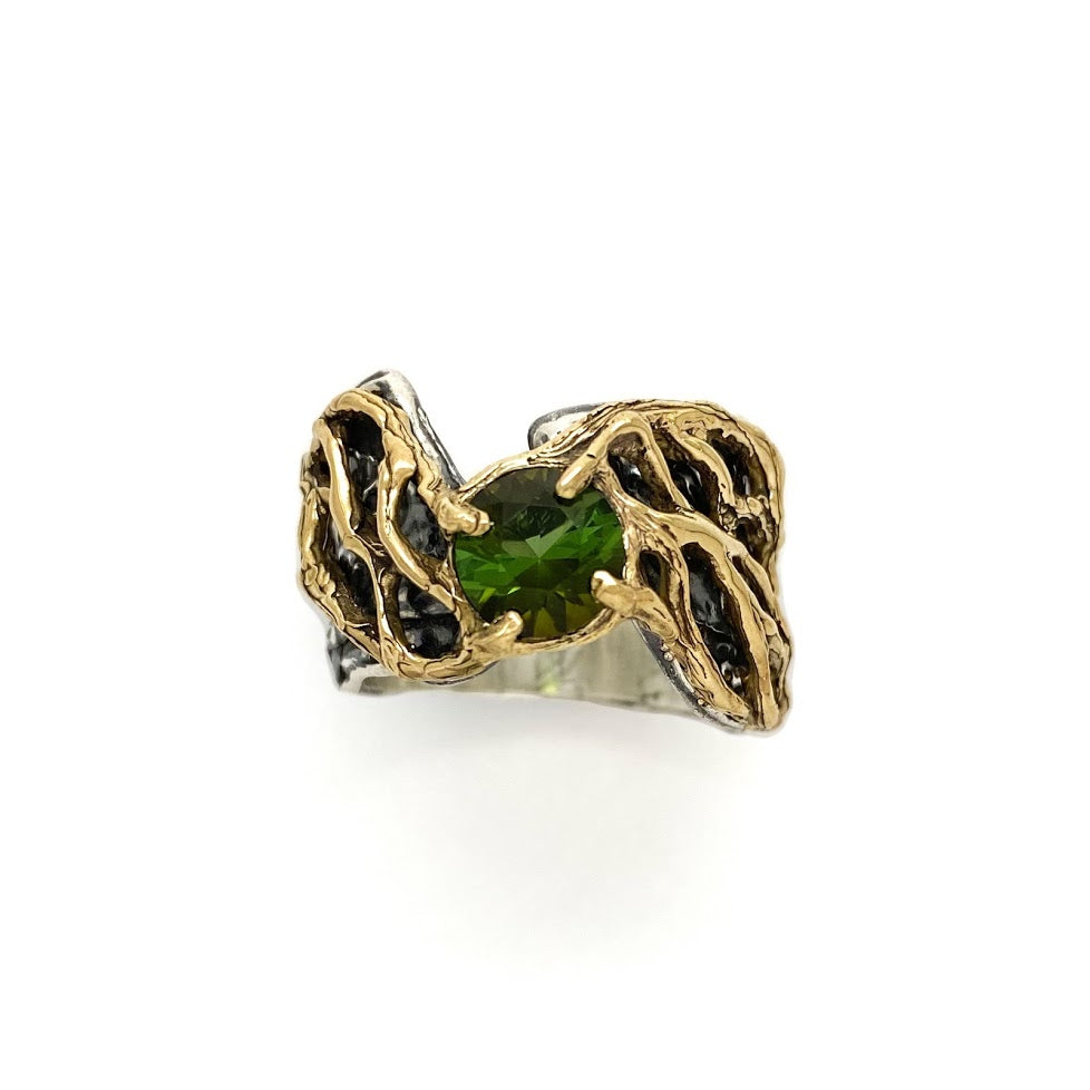 Gold lace over fluid silver band set with a green tourmaline