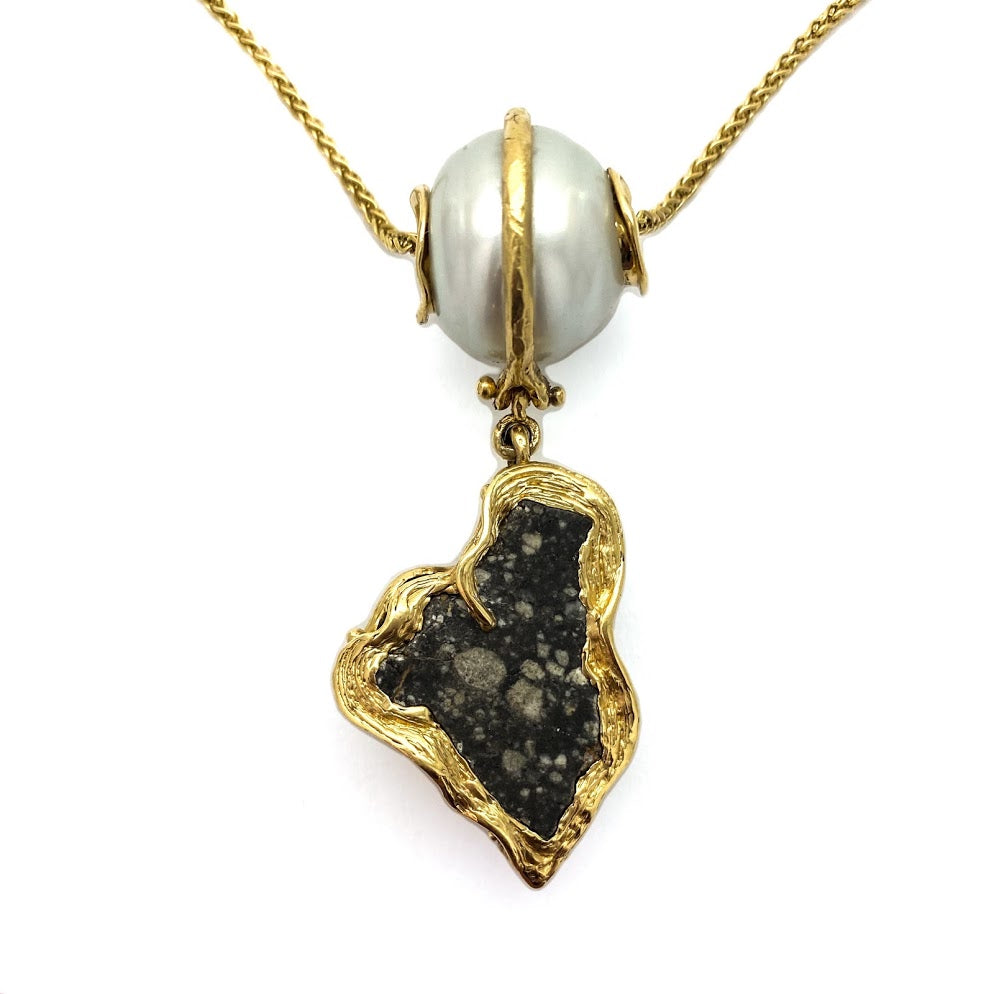 Lunar Meteorite hanging from a South Sea pear slide. Legend has it, pearl is the gem of the Moon.