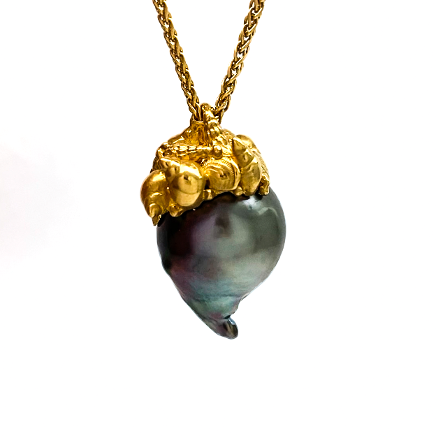 Baroque rainbow Tahitian pear with a micro sea shell cap