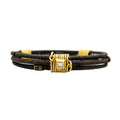 Three old African wrought iron "money" bracelets lashed together with 22K gold wires and set with diamonds