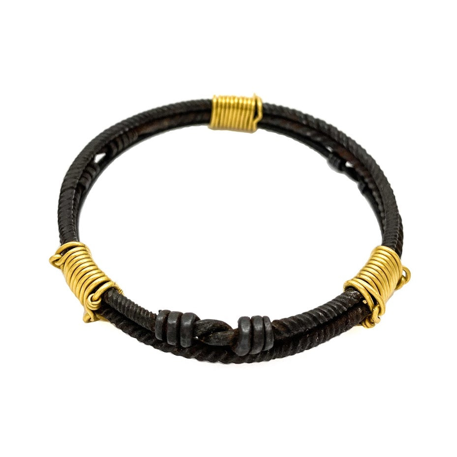 Three old African wrought iron "money" bracelets lashed together with 22K gold wires